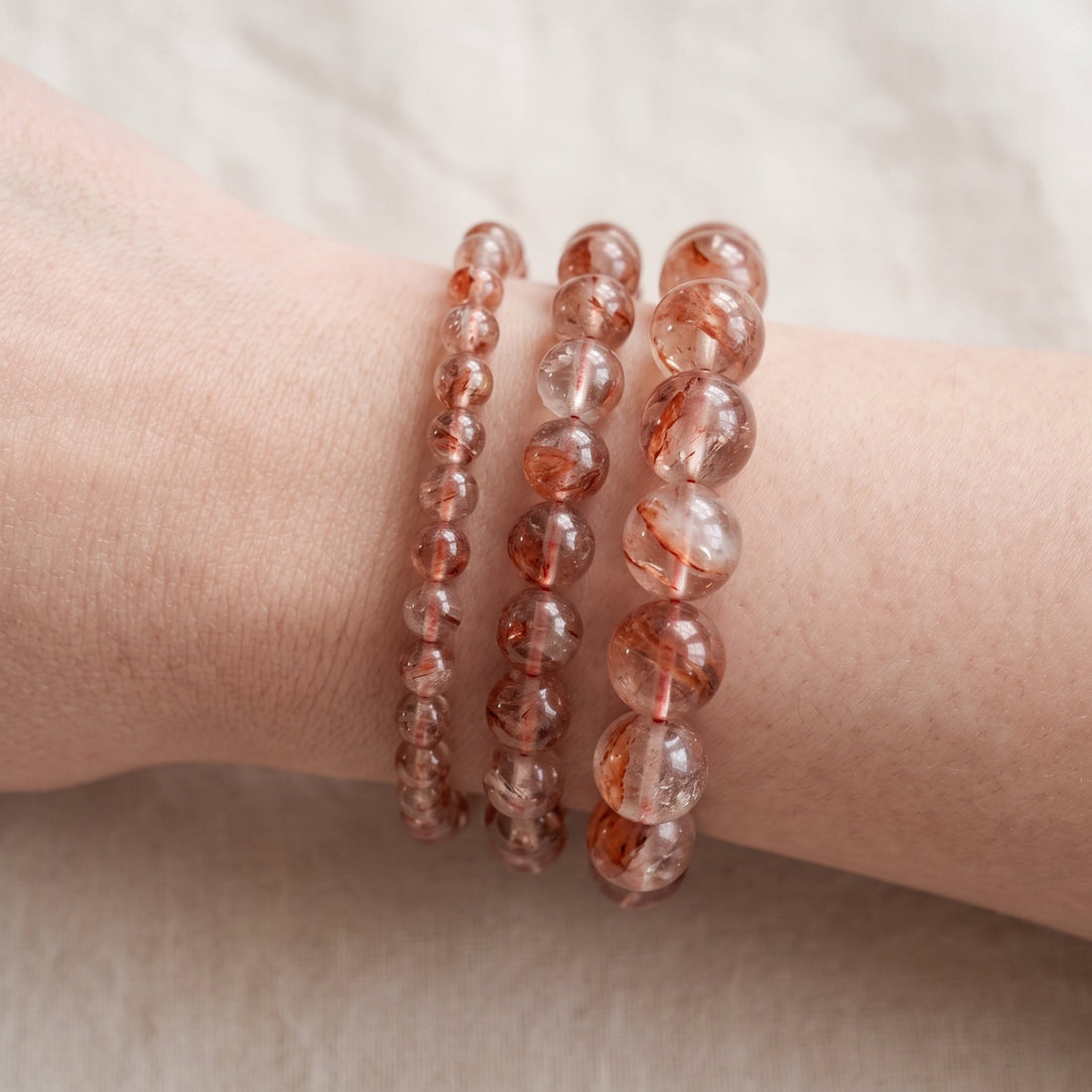 Trois bracelets en quartz hématoïde de diamètres différents, portés ensemble au poignet - visuel provisoire