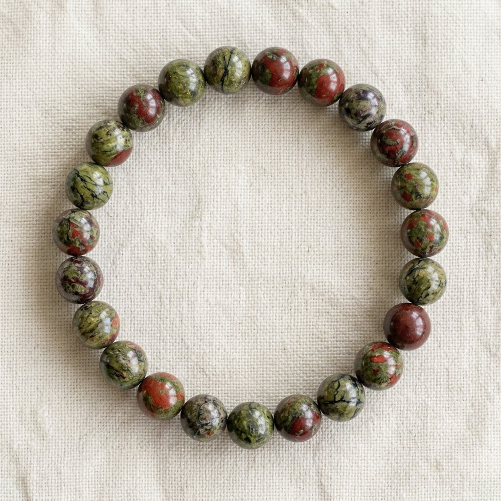 Bracelet en jaspe sang de dragon : perles rondes de pierre naturelle de 8 mm sur elastique, sans interperle (variante temporaire), vu de dessus sur du lin ivoire - visuel provisoire
